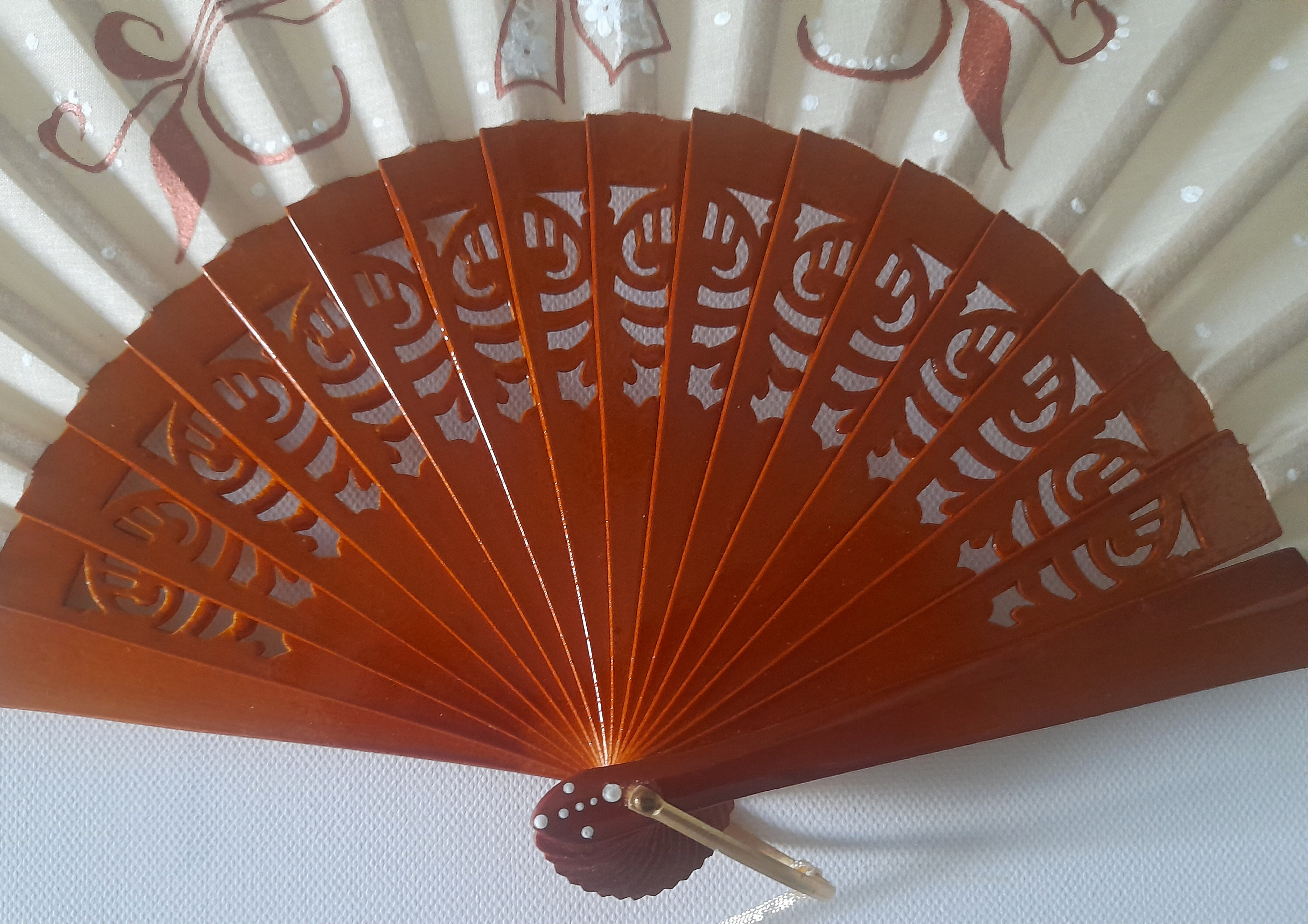 Éventail artisanal en bois ajouré et coton peint main.