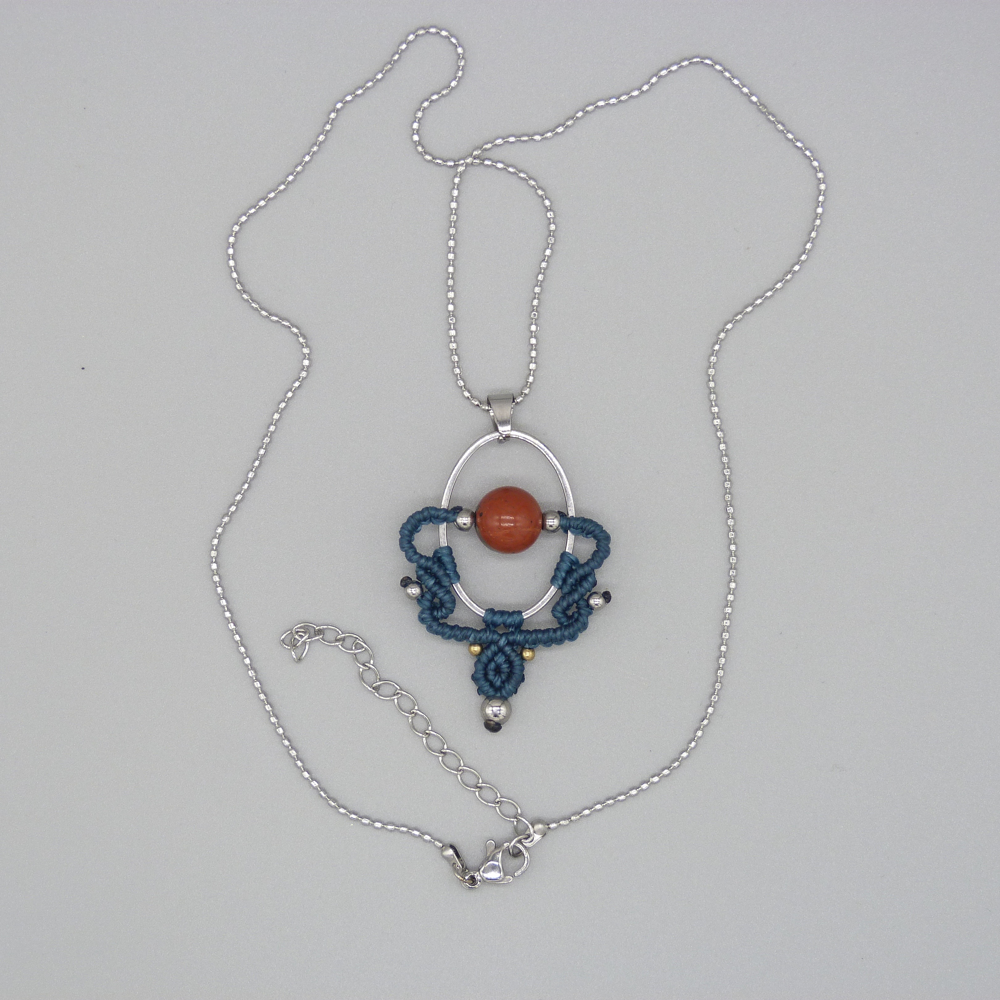Collier couleur bleu canard en micro-macram&eacute;  avec une perle jaspe rouge