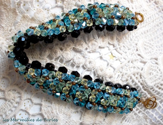 Glittrande Aurora-armband med svarta facetter och färgade snurrande toppar i Swarovski-kristall
