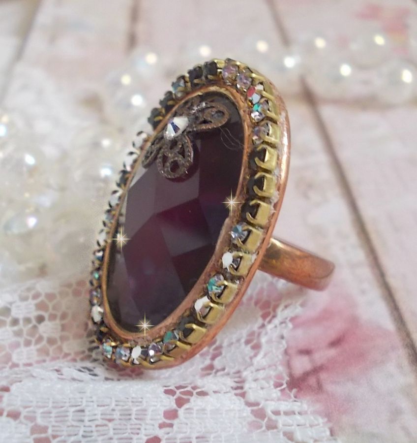 Chic burgundy ring skapad med PureCrystal kristaller, en blommaformad stämpel och en glascabochon.