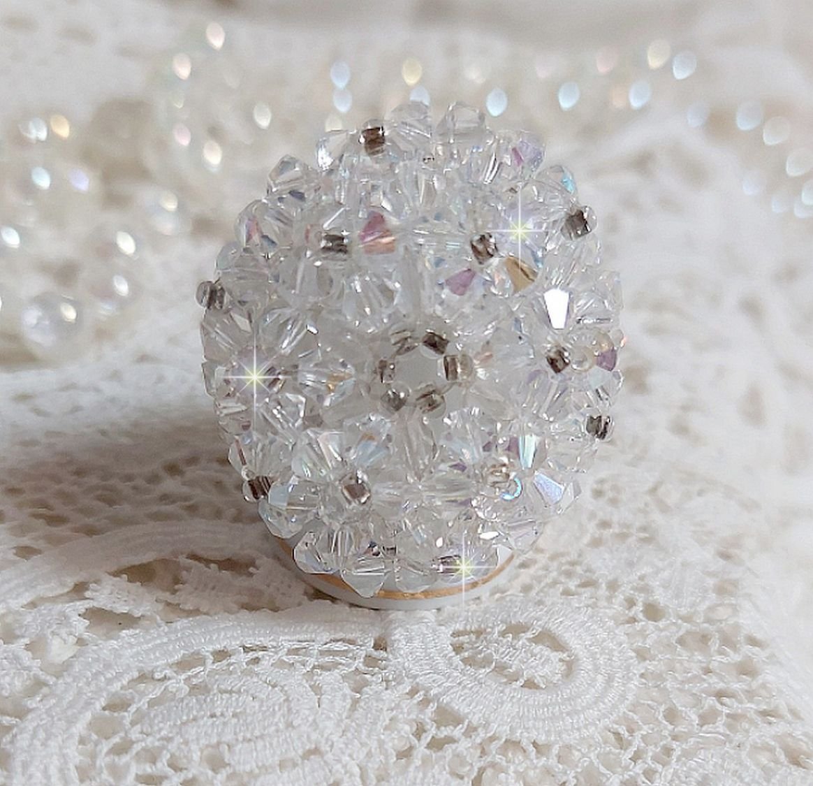 Flockring med facetter och snurrande toppar i Swarovski-kristall