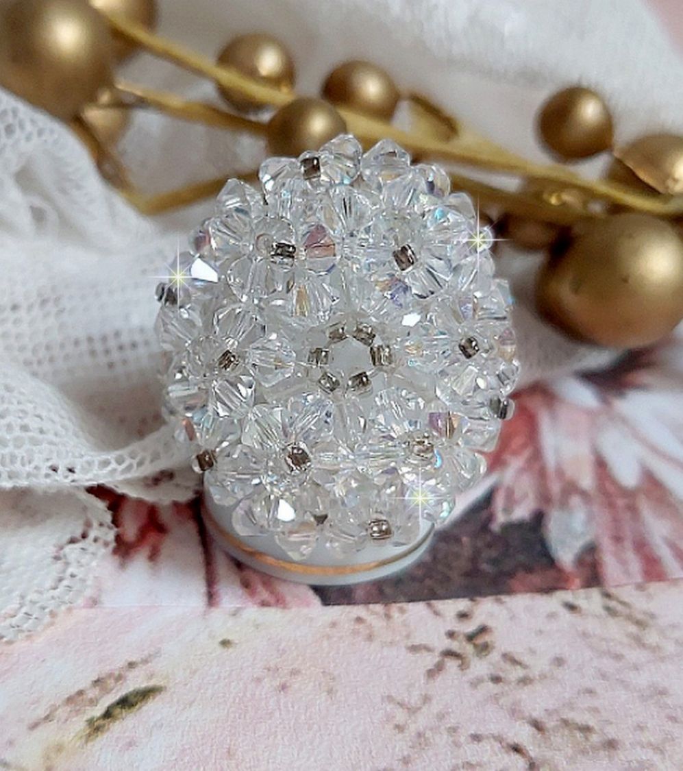 Flockring med facetter och snurrande toppar i Swarovski-kristall