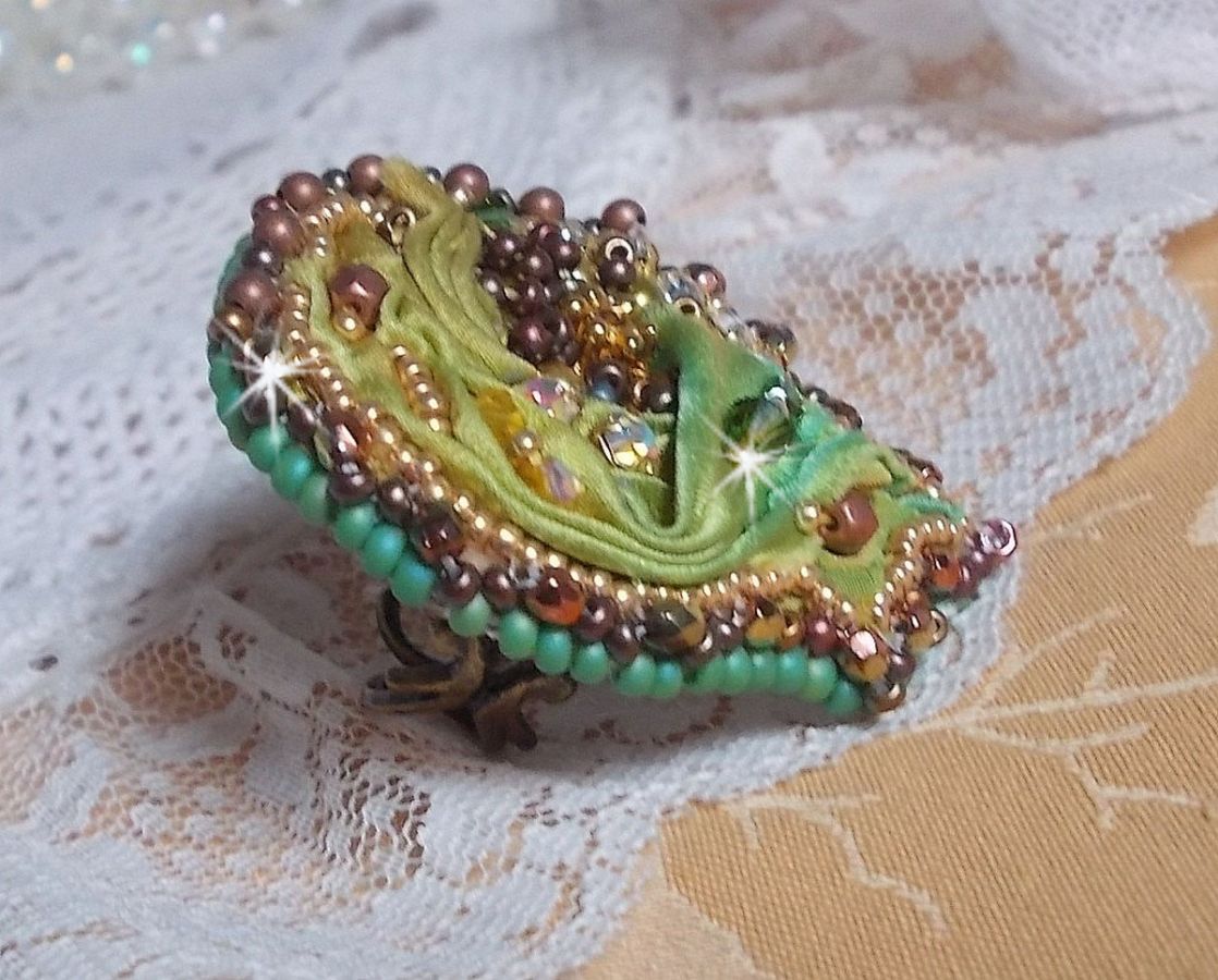 Venetiansk månring broderad med kameleonfärgat sidenband, Swarovskikristaller, olika pärlor och fröpärlor.