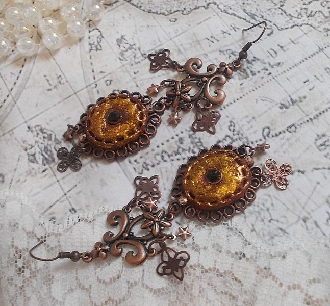 BO Myst&egrave;res d'Ars&egrave;ne skapad med olika formade berlocker, h&auml;ngande medaljonger, patinerade porslinsmotiv och Swarovski-kristaller.