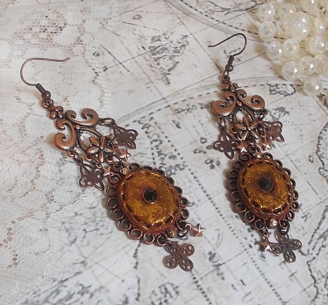 BO Myst&egrave;res d'Ars&egrave;ne skapad med olika formade berlocker, h&auml;ngande medaljonger, patinerade porslinsmotiv och Swarovski-kristaller.