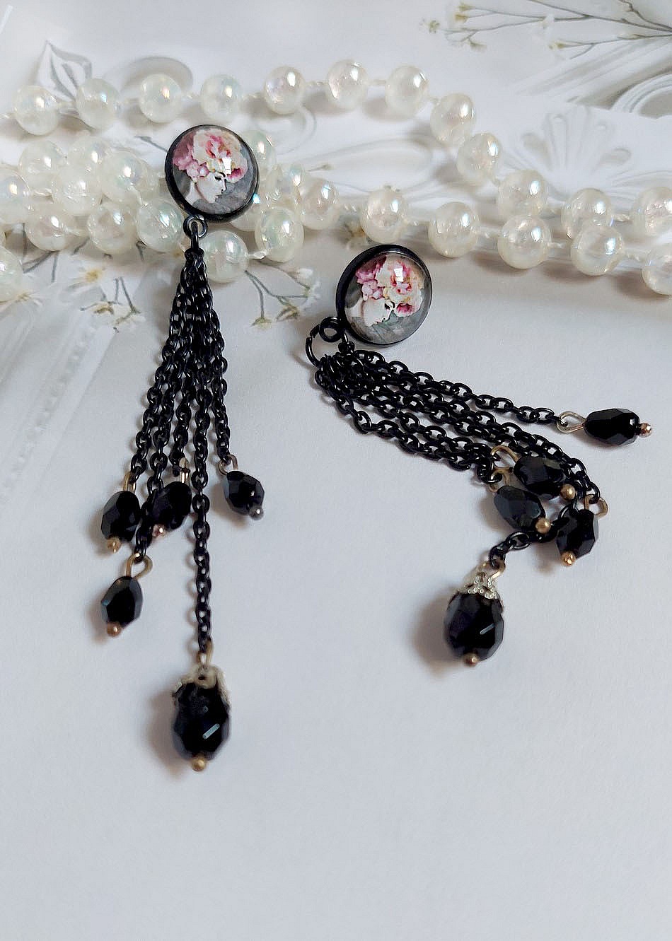Boucles d'oreilles bohèmes noires avec cabochons fleuris et chaînes.