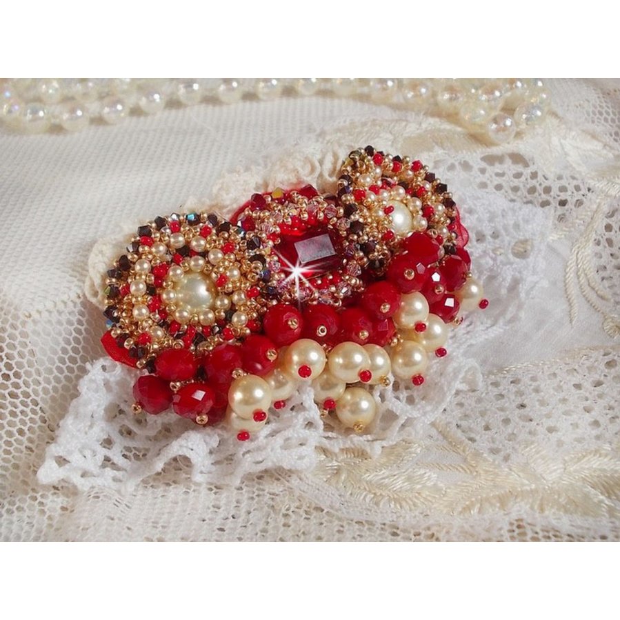 Rubinbrosch broderad med en bohemisk glascabochon från 1960-talet, pärlor, Swarovskikristaller och fröpärlor.