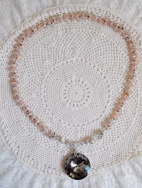 Coco h&auml;ngande halsband broderat med Swarovskikristaller och en medaljong i r&ouml;kt kristall